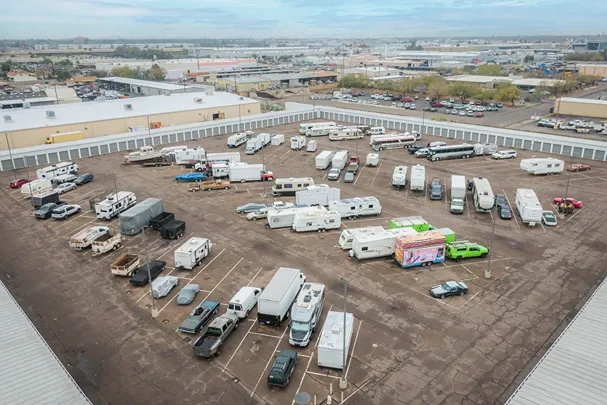 Outdoor RV and vehicle storage parking area with multiple trailers and campers